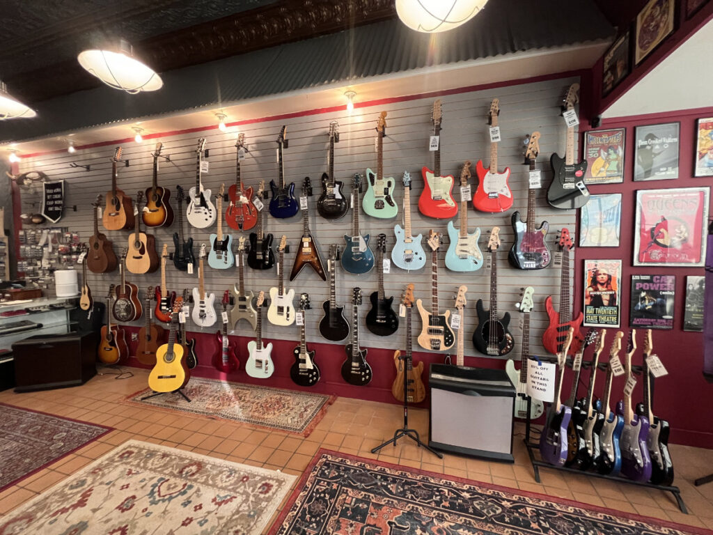 guitar wall at repair shop at fat cat custom guitars 02