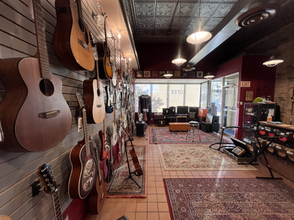 guitar wall at repair shop at fat cat custom guitars